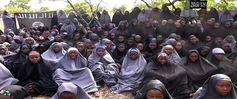 A screengrab from a video of Nigerian Islamist extremist group Boko Haram, obtained by AFP, shows some of the kidnapped girls wearing the full-length hijab and praying in an undisclosed rural location. The group's leader, Abubakar Shekau, claims the girls had converted to Islam and would not be released until all militant prisoners were freed. AFP Photo