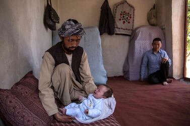 Ahmed Reza, 34, holds his son Abbas at his home in Kabul. His wife Rokaia was killed in the attack on the maternity ward in Dasht-e-Barchi. Stefanie Glinski for The National