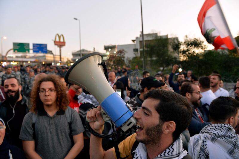 Protesters shout slogans as they block the highway leading to the Presidential palace during a protest to demand the formation of a new government in Baabda, east Beirut.  EPA