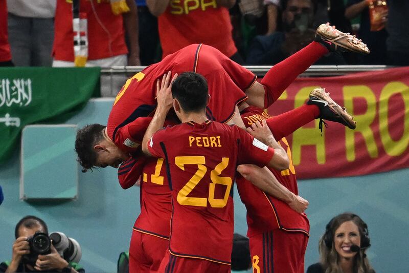 Spain's Ferran Torres celebrates with his teammates after scores his team's third goal from the penalty spot. AFP