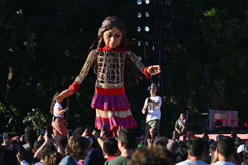 Little Amal, the giant puppet of a Syrian refugee girl aged 10, towers over the crowd during the Global Citizen Festival at Central Park in New York. AFP