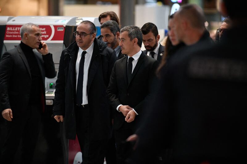 French Interior Minister Gerald Darmanin, third left, arrives at Gare du Nord train station. AFP