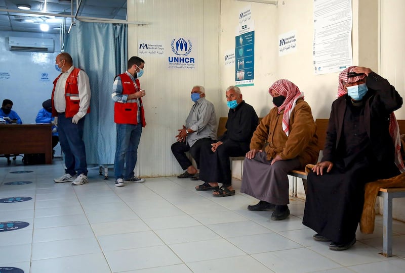 Syrian refugees wait to receive their vaccine at Zaatari. AFP