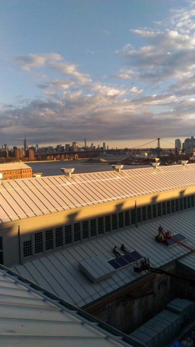 Workers repairing a roof at the Brooklyn Naval Yard, New York. Photo : John S Moller