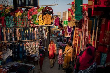 A woman walks through a market on the outskirts of New Delhi. Concerns over a flood of cheap imports from China led to India backing out of plans to join the REgional Comprehensive Economic Partnership, which became the world's largest trade bloc last week. AP Photo 