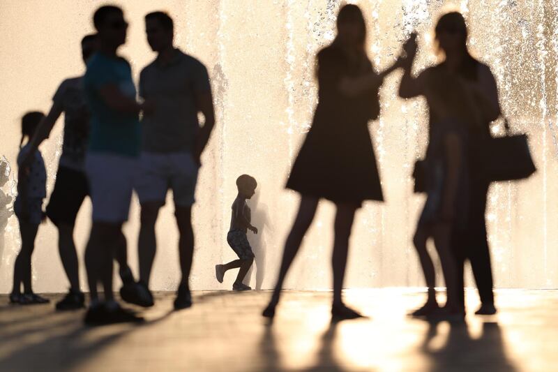 People attempt to cool off beside a fountain during a heat wave in the center Volgograd, Russia. Zurab Kurtsikidze / EPA