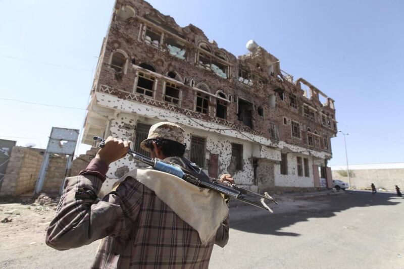 A Shiite Houthi rebel walks along a street in Sanaa. The group have taken control of the capital and have placed the president under house arrest. (Photo: REUTERS/Mohamed al-Sayaghi)