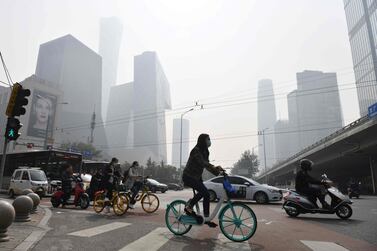 People cross a road in Beijing. China’s economy has regained all the losses made in the first half, with the recovery first driven by exports and industrial output and then strengthening as consumption picked up. AFP