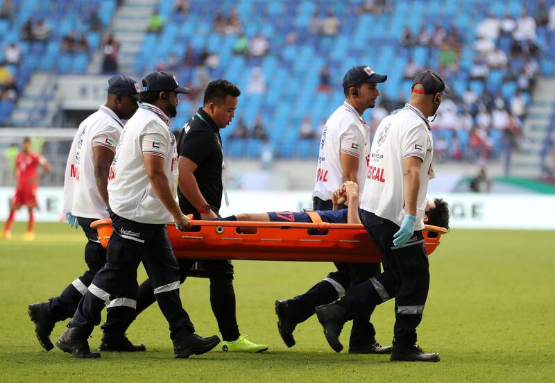Dubai, United Arab Emirates - January 10, 2019: Tanaboon Kesarat of Thailand is stretchered off during the game between Bahrain and Thailand in the Asian Cup 2019. Thursday, January 10th, 2019 at Al Maktoum Stadium, Abu Dhabi. Chris Whiteoak/The National