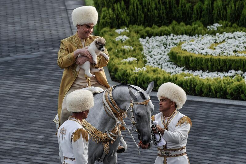 Turkmenistan's President Gurbanguly Berdymukhamedov holds a Turkmen shepherd dog, locally known as Alabai, as he takes part in celebrations for the Day of the Horse in Ashgabat. Igor Sasin / AFP