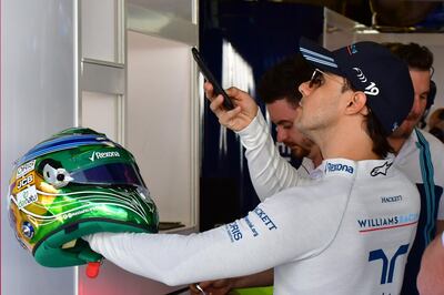 Williams' Brazilian driver Felipe Massa takes a picture of his helmet during the first practice session ahead of the Abu Dhabi Formula One Grand Prix at the Yas Marina circuit on November 24, 2017.  / AFP PHOTO / GIUSEPPE CACACE