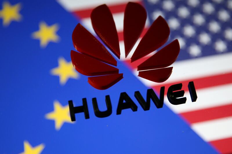 FILE PHOTO: A 3D printed Huawei logo is placed on glass above a display of EU and US flags in this illustration taken January 29, 2019. REUTERS/Dado Ruvic/Illustration/File Photo