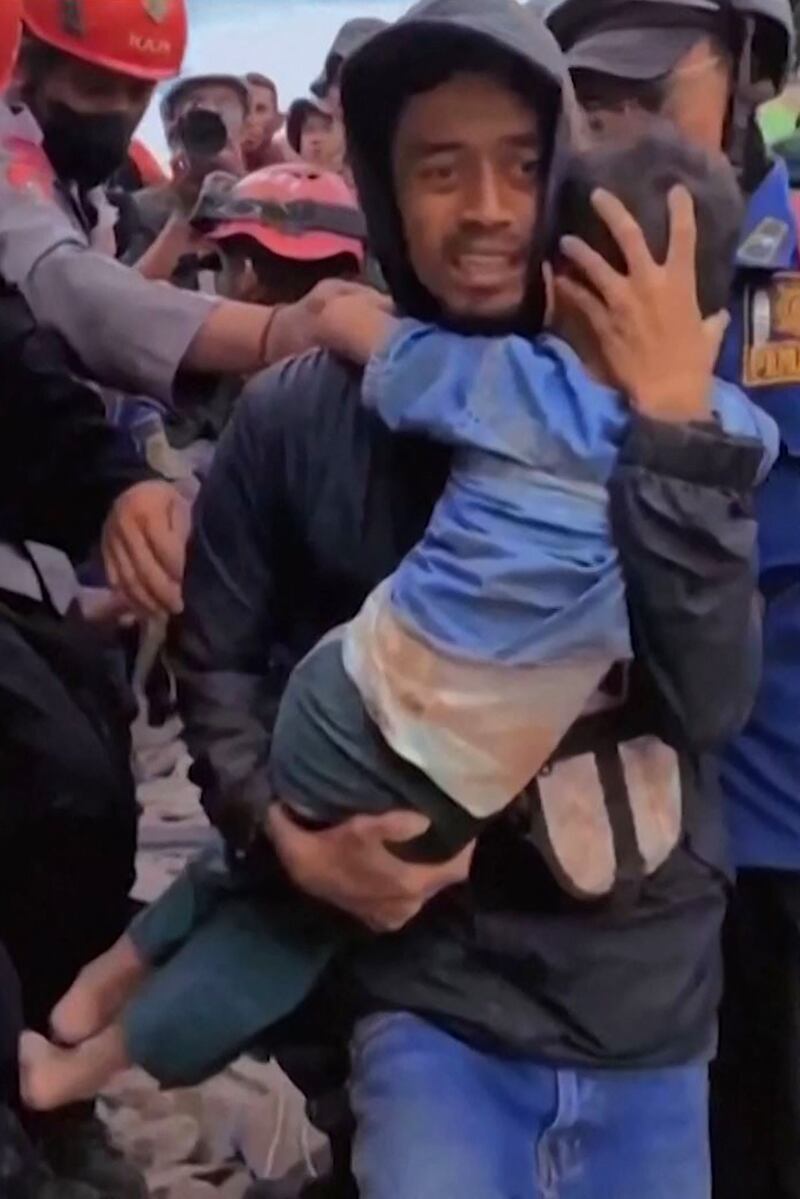 A boy, six, is pulled out of the rubble in Cianjur, West Java, after a 5.6-magnitude earthquake that hit the area this week, killing at least 271 people, many of them children. AFP