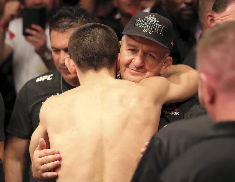 Abu Dhabi, United Arab Emirates - September 07, 2019: Khabib hugs his dad. Lightweight title bout between Khabib Nurmagomedov (black shorts, winner) and Dustin Poirier in the main event at UFC 242. Saturday the 7th of September 2019. Yas Island, Abu Dhabi. Chris Whiteoak / The National