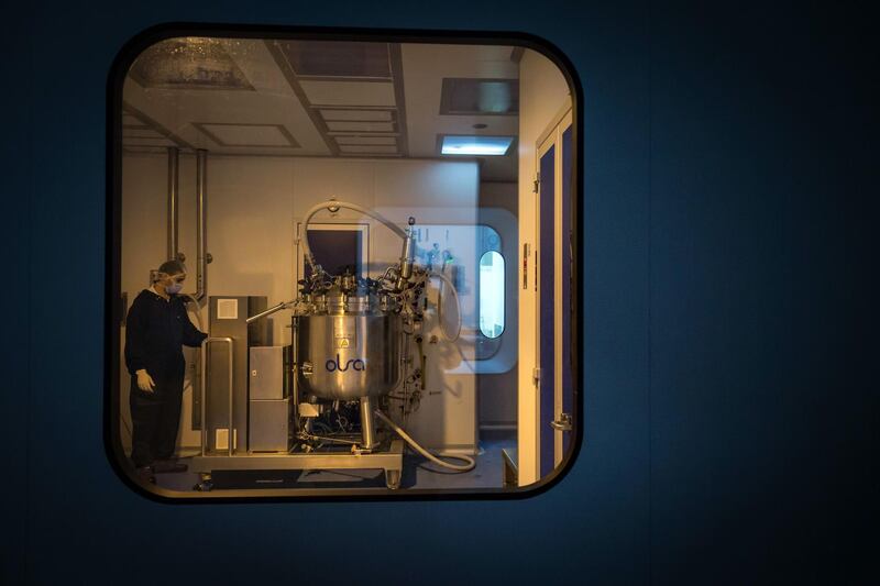 A laboratory technician dissolves an active ingredient for Remdisivir anti-viral drug in a tank for used for its mass production at the Eva Pharma facility in Cairo, Egypt. Bloomberg