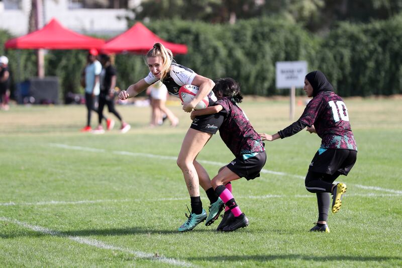 Dubai Falcons battle with Al Maha in the UAE women's rugby sevens at Sharjah Wanderers Sports Club. Khushnum Bhandari / The National
