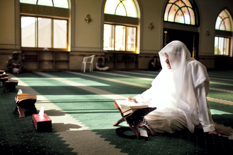 A man reads passages of Quran during his afternoon prayers at a mosque on the outskirts of  the Khalidiya neighborhood in Abu Dhabi on Tuesday evening, August 1, 2011, the first day of Ramadan. (Silvia Razgova/The National)


