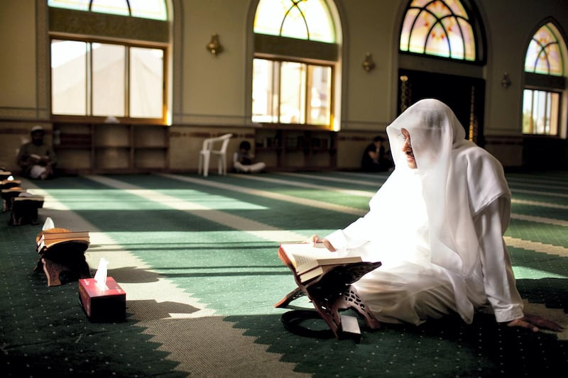 A man reads passages of Quran during his afternoon prayers at a mosque on the outskirts of  the Khalidiya neighborhood in Abu Dhabi on Tuesday evening, August 1, 2011, the first day of Ramadan. (Silvia Razgova/The National)

