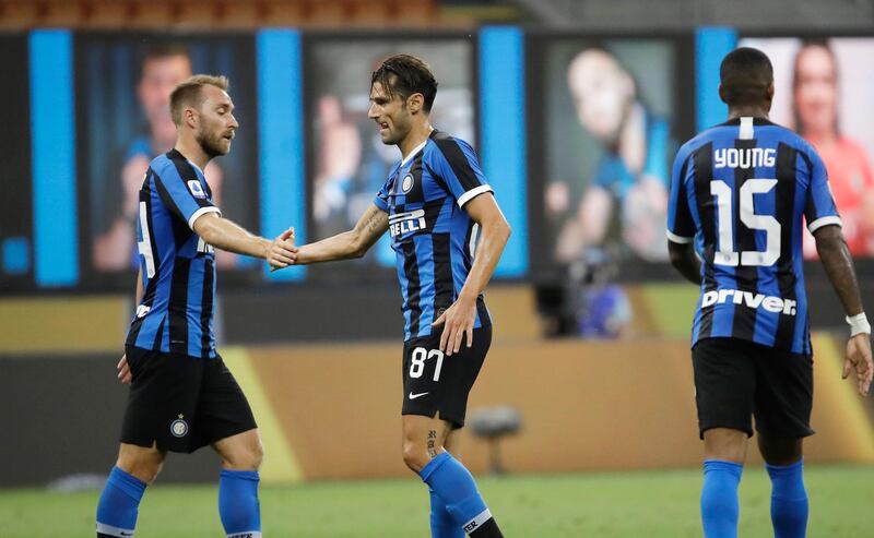 Inter Milan's Antonio Candreva, centre, celebrates with Christian Eriksen, left, after scoring his side's sixth goal. AP Photo