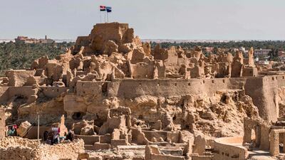 This picture shows a view of the recently restored fortress of Shali and its surroundings, in the Egyptian desert oasis of Siwa, some 600 kms southwest of the capital Cairo, on November 6, 2020.  The 13th century edifice, called Shali or "Home" in the Siwi language, was built by Berber populations, using kershef, a mixture of clay, salt and rock which acts as a natural insulator in an area where the summer heat can be scorching.
After it was worn away by erosion, and then torrential rains in 1926, the European Union and Egyptian company Environmental Quality International (EQI) from 2018 sought to restore the building, at a cost of over $600,000.
 / AFP / Khaled DESOUKI
