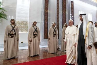 ABU DHABI, UNITED ARAB EMIRATES - February 3, 2019: Day one of the UAE papal visit - HH Sheikh Mohamed bin Zayed Al Nahyan, Crown Prince of Abu Dhabi and Deputy Supreme Commander of the UAE Armed Forces (R), receives His Holiness Pope Francis, Head of the Catholic Church (2nd R), at the Presidential Airport. ( Mohamed Al Hammadi / Ministry of Presidential Affairs ) ---