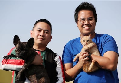 Nurses Joshua Aldrin De Vera, right, and Ryan Cayamanda stayed at Pet First Veterinary Clinic through the severe storms in Dubai to keep sick animals safe. Chris Whiteoak / The National