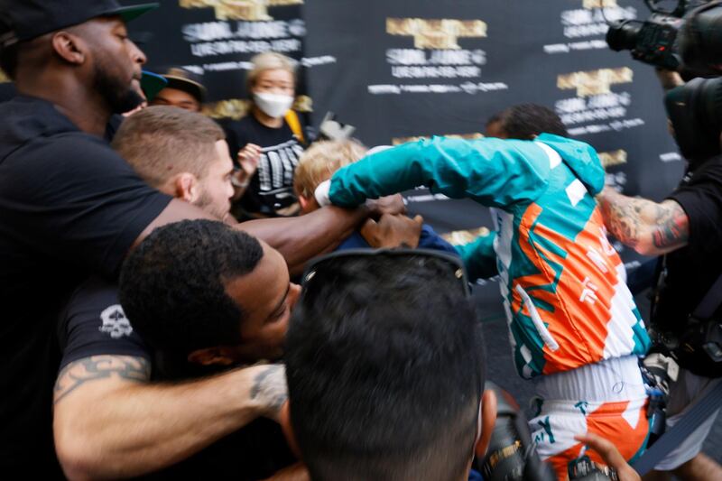 Floyd Mayweather appears to throw a punch at Jake Paul scuffle as the pair scuffle following the media day for Mayweahter's exhibition bout with Logan Paul. AFP