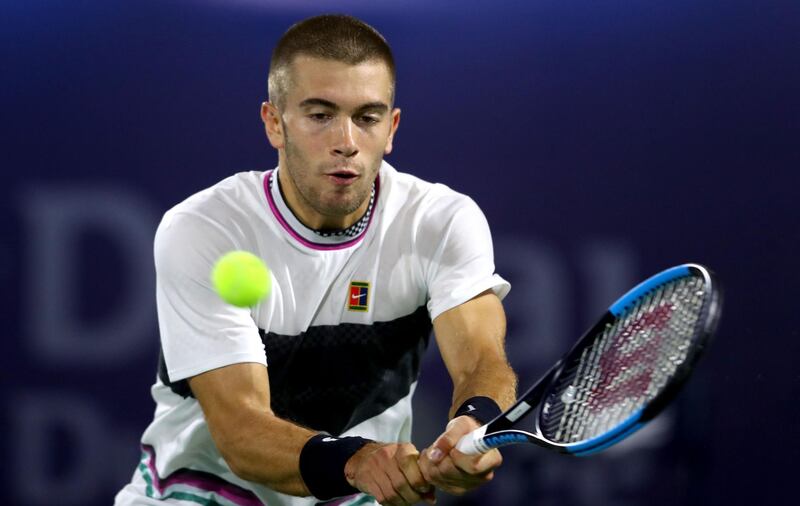 DUBAI, UNITED ARAB EMIRATES - FEBRUARY 28:   Borna Coric of Croatia plays a backhand against Nikoloz Basilashvili of Georgia during day twelve of the ATP Dubai Duty Free Tennis Championships at Dubai Duty Free Tennis Stadium on February 28, 2019 in Dubai, United Arab Emirates. (Photo by Francois Nel/Getty Images)