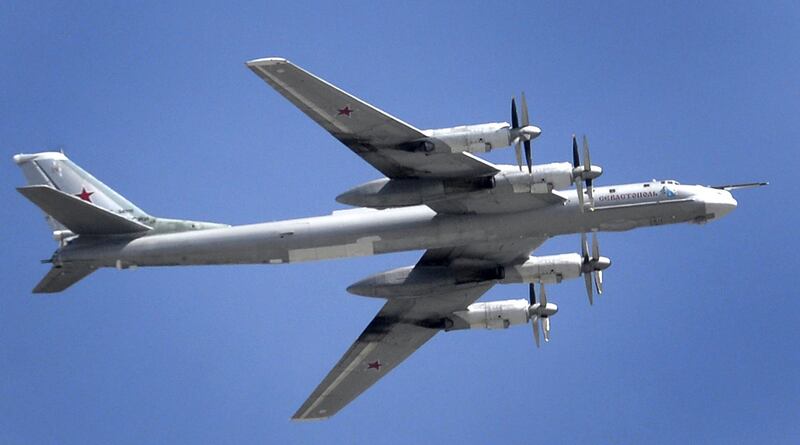 A Russian Tupolev Tu-95 turboprop-powered strategic bomber flies above the Kremlin in Moscow, on May 7, 2015, during a rehearsal for the Victory Day military parade. A strategic bomber with seven people on board crashed in far eastern Russia on July 14 but its crew apparently managed to parachute out and a search for them was underway, the defence ministry said. AFP PHOTO / ALEXANDER NEMENOV (Photo by ALEXANDER NEMENOV / AFP)