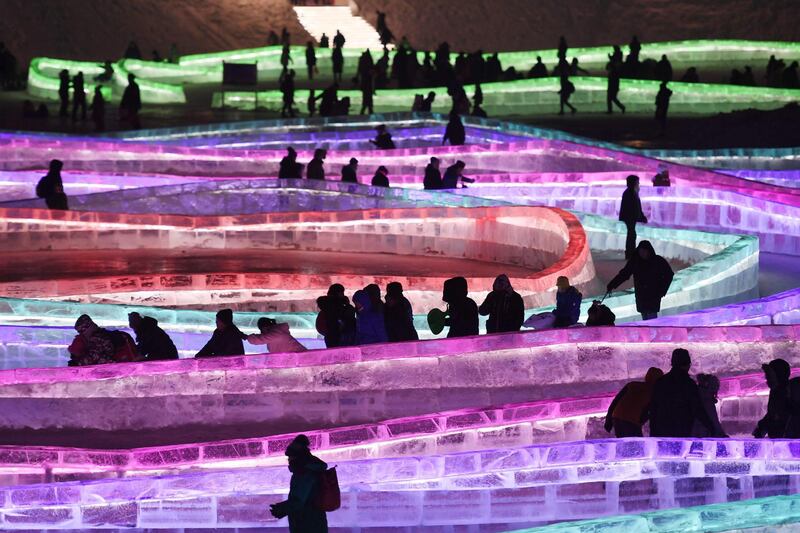 Visitors walk and slide on icy paths on the opening day of the annual Harbin Ice and Snow Sculpture Festival in Harbin, in China's northeast Heilongjiang province. The festival, featuring dozens of huge ice sculptures lit up by coloured lights, attracts hundreds of thousands of visitors annually. Greg Baker / AFP