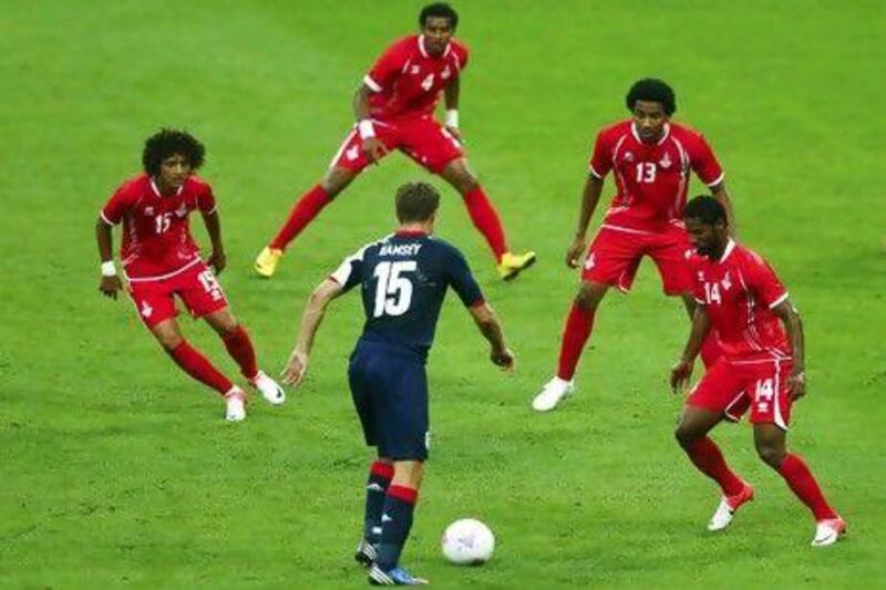 From left to right, the UAE’s Omar Abdulrahman, Mohamed Ahmad, Khamis Ismail and Abdelaziz Sanqour look to stop Britain’s midfielder Aaron Ramsey. Eddie Keogh / Reuters