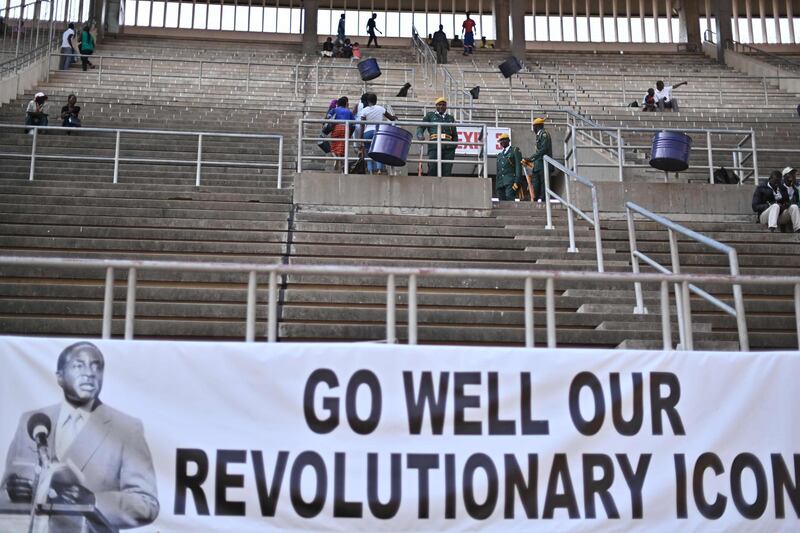 People sit and wait at the National Sports stadium where the official funeral for Robert Mugabe is to be held in Harare, on September 14, 2019. Former Zimbabwe leader Robert Mugabe will be given a state funeral with a dozen African leaders expected to pay tribute to a man lauded as a colonial-era liberation hero. Mugabe, who died last week in Singapore aged 95, left Zimbabwe torn over the legacy of his 37-year rule marked by brutal repression and economic crisis. AFP