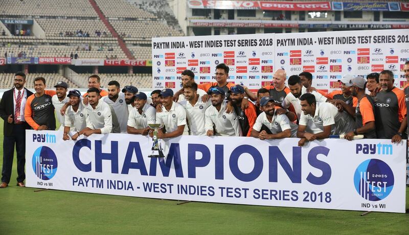 Indian cricket team poses for photographs with the trophy after winning the India West Indies test series in Hyderabad, India, Sunday, Oct. 14, 2018. (AP Photo/Mahesh Kumar A.)