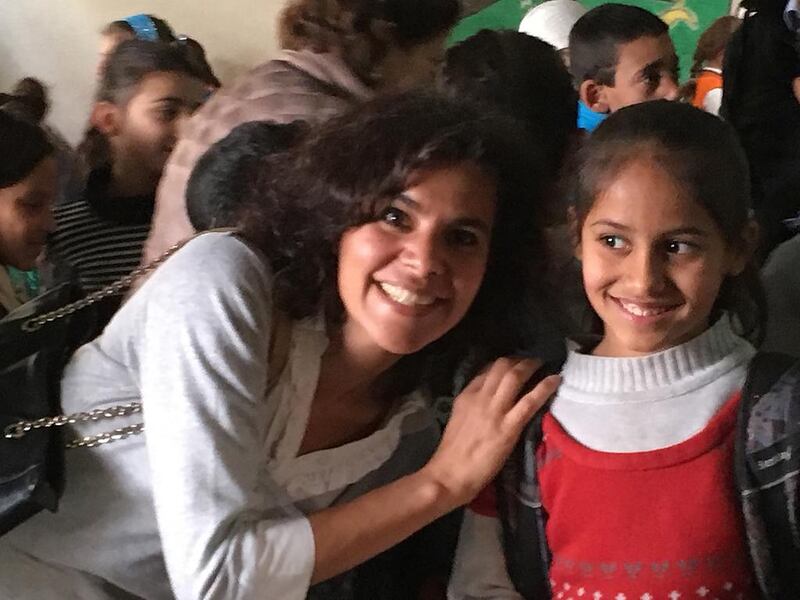 Rudayna Abdo, founder of NGO Thaki, posing with a Syrian child at a Social Support Society school in the Bekaa Valley in Lebanon. Thaki seeks to provide laptops from donors to centres educating refugee and disadvantaged children in Lebanon and Jordan. Courtesy Rudayna Abdo