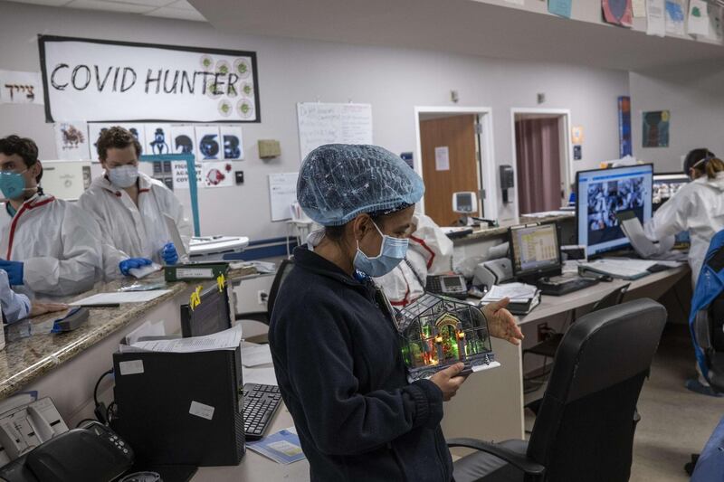 Medical staff member Anita Pandey holds a Christmas decoration at the nursing station in the Covid-19 ward at the United Memorial Medical Centre in Houston, Texas.  AFP