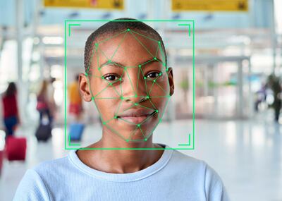 Green face recognition markings on the face of a short-haired young woman in an airport building. Cape Town, South Africa. May 2019. Getty Images