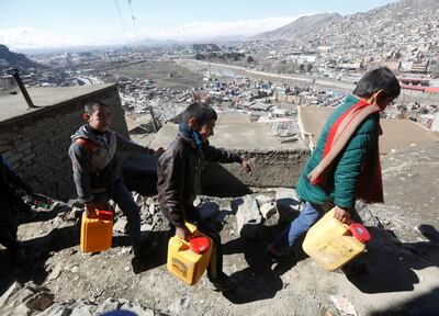 Boys return home after fetching water in Kabul, Afghanistan. Reuters 