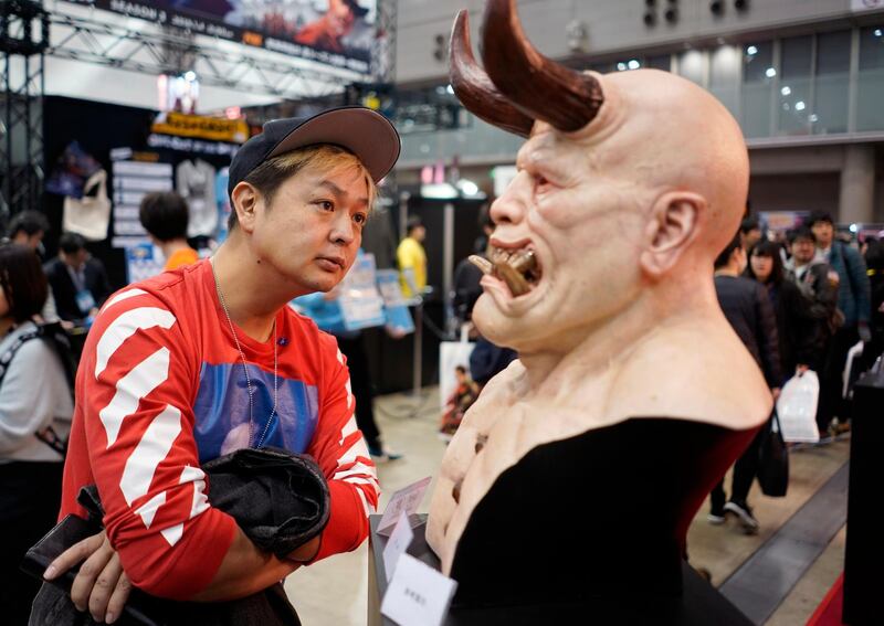 A visitor looks at artwork displayed during the Tokyo Comic Con 2018 at Makuhari Messe in Chiba, Japan. EPA