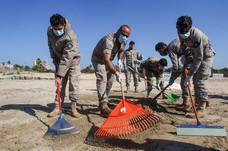 Masked and gloved volunteers were faced with beaches in the southern city of Tyre polluted by about 1.2 million tonnes of tar, Lebanese officials said. AFP