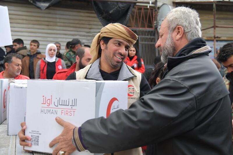 Emirates Red Crescent workers distribute the food parcels. Wam