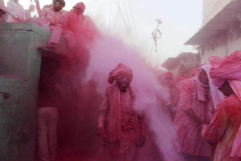 Indian villagers throw coloured powder over others during Lathmar Holi celebrations in the village of Jaab in Kosi Kalan. Holi, is celebrated at the end of the winter season on the last full moon day of the lunar month. Chandan khanna / AFP Photo