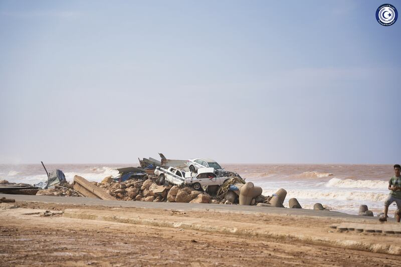 Cars piled on the sea bank in Derna, after being carried away by floodwater. AP