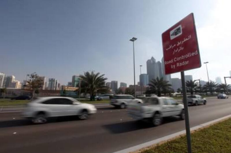 Feb 8, 2011 / Abu Dhabi / Motorist drive along the Corniche past a sign postings warning of speed enforcement, by radar February 8, 2011. (Sammy Dallal / The National) *** Local Caption *** na17ju-letter_speeding.jpg