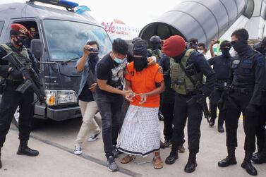 Police escort 57-year-old Zulkarnaen, a senior leader of the Al-Qaeda-linked Jemaah Islamiyah, who had been on the run for his alleged role in the 2002 Bali bombings, upon arrival at Jakarta’s Soekarno-Hatta International Airport in Tangerang on December 16, 2020. (Photo by FAJRIN RAHARJO / AFP)