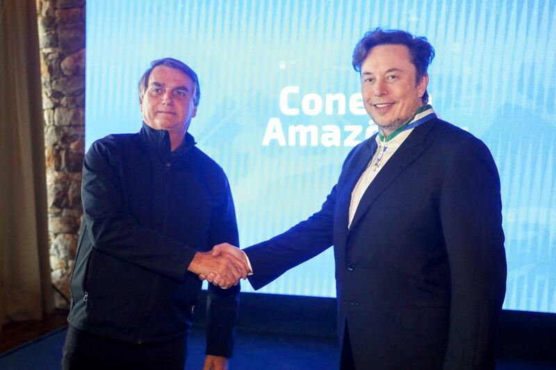 Mr Musk shakes hands with Brazil's then president Jair Bolsonaro, at the event Conecta Amazonia in Porto Feliz, Sao Paulo state, in 2022 AFP