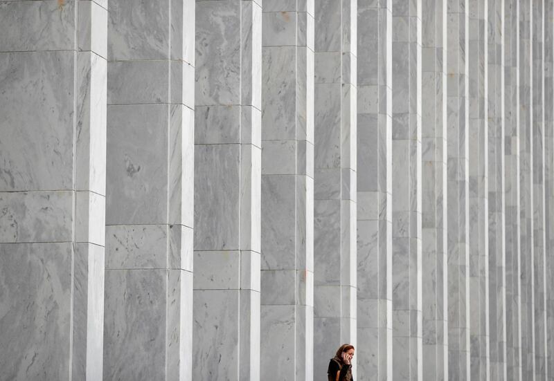 A woman speaks on her phone in front of The Library of Congress John Adams Building in Washington, US. Reuters
