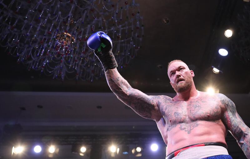 Professional strongman and actor Hafthor Bjornsson raises his glove after his exhibition bout against Simon Vallily in Dubai. EPA