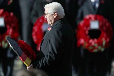 Germany's President Frank-Walter Steinmeier lays a wreath, during the remembrance service at the Cenotaph memorial in Whitehall, central London, on the 100th anniversary of the signing of the Armistice which marked the end of the First World War, in London, Sunday, Nov. 11, 2018. (Andrew Matthews/ PA via AP)