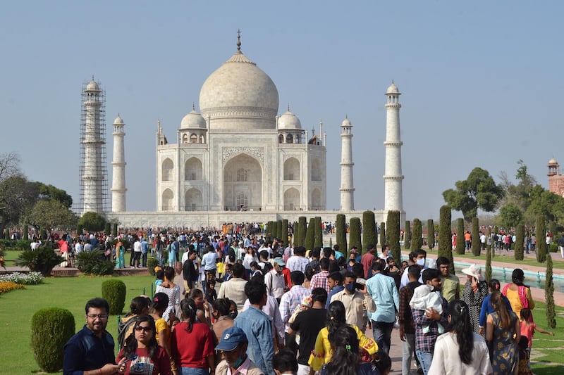Tourists visit the Taj Mahal during the annual 'Urs' or death anniversary of fifth Mughal emperor Shah Jahan, who built the Taj Mahal, in Agra on March 11, 2021. (Photo by Pawan SHARMA / AFP)