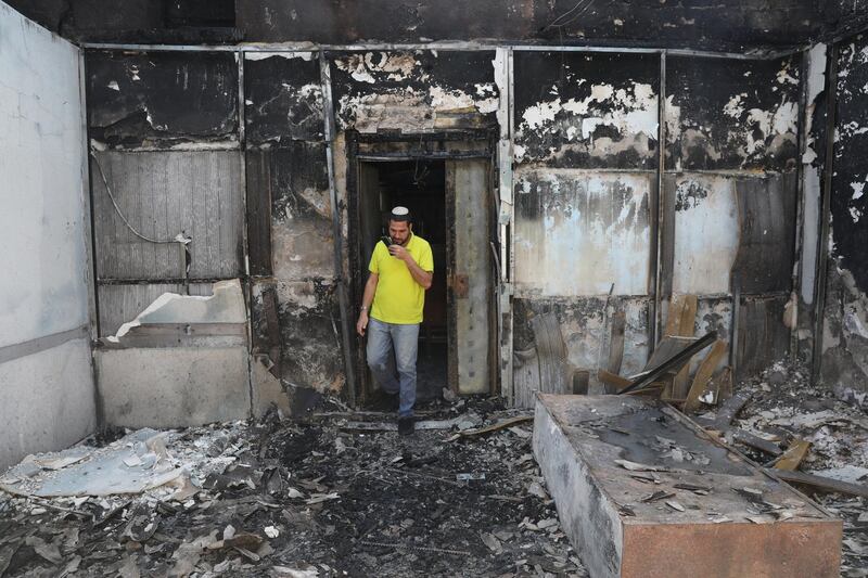 A Jewish man at a burnt-out synagogue after overnight riots between Arab and Jewish residents in Lod, Israel. EPA